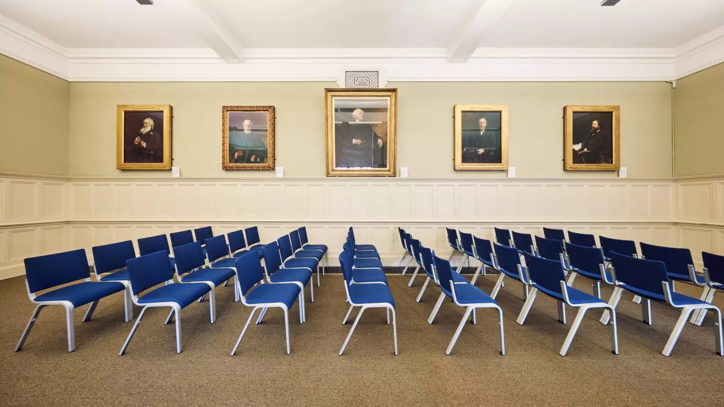 Room 9 at the Examination Schools, theatre-style with portraits