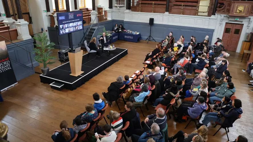a lecture in the Sheldonian Theatre, with an audience facing the stage