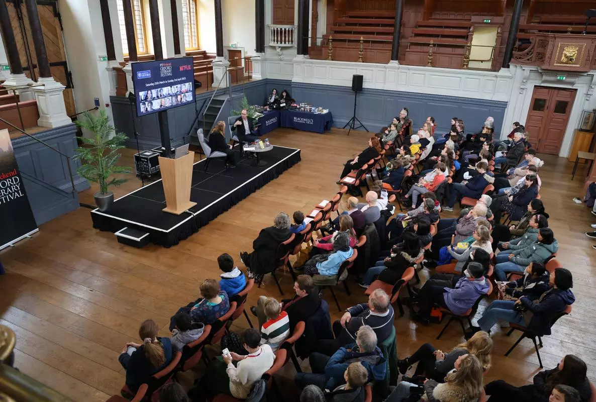 a lecture in the Sheldonian Theatre, with an audience facing the stage
